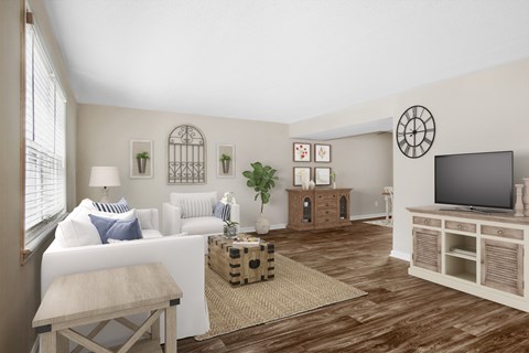 a living room with a white couch and a television